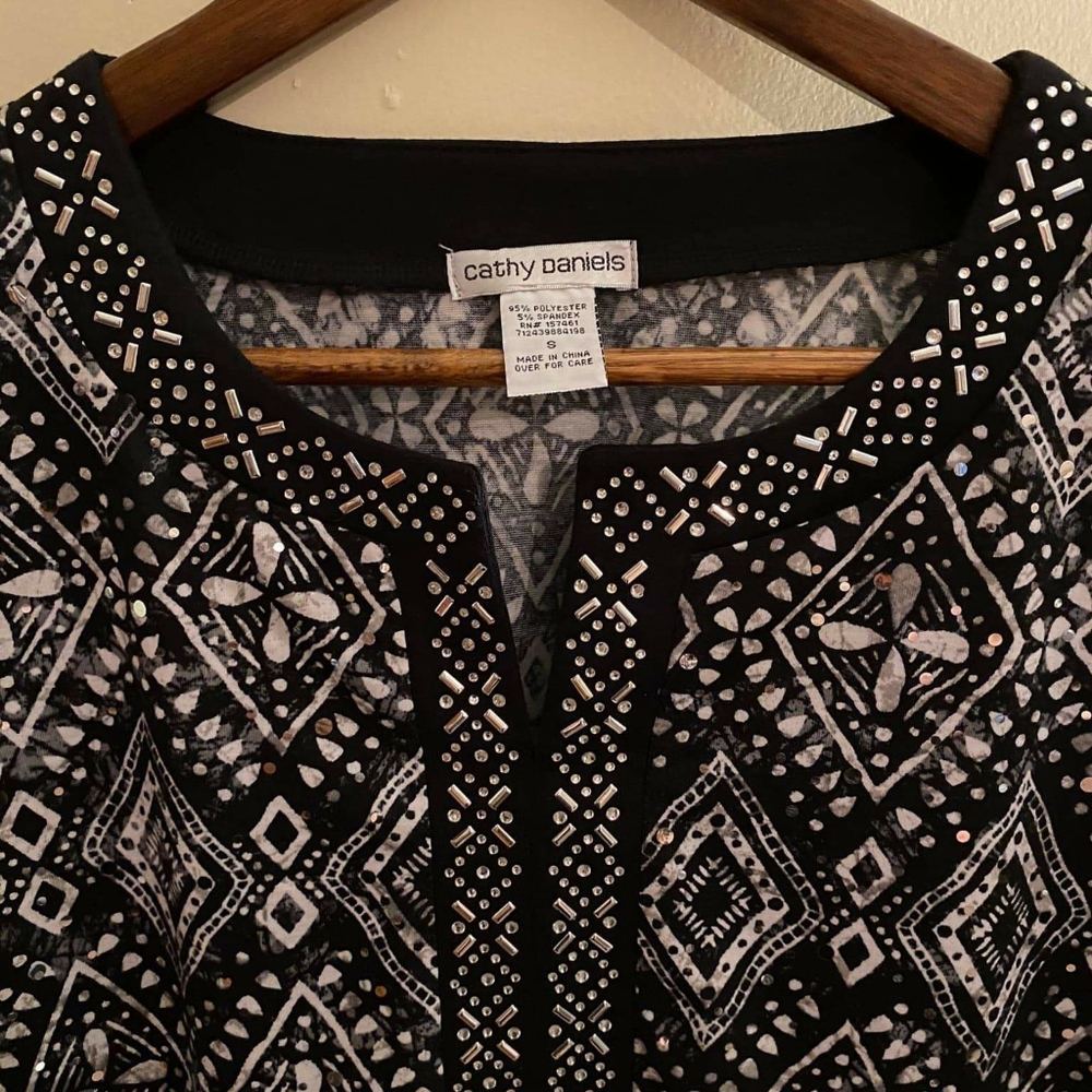 Black, with white diamond shapes, blouse.